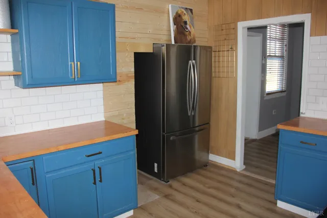 a kitchen with stainless steel appliances granite countertop a refrigerator and a stove top oven