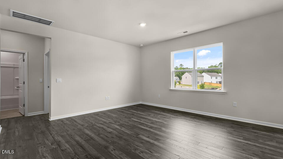 1277 Pavo Path Wendell, NC 27591 - Photo 14 of 53 an empty room with wooden floor and windows