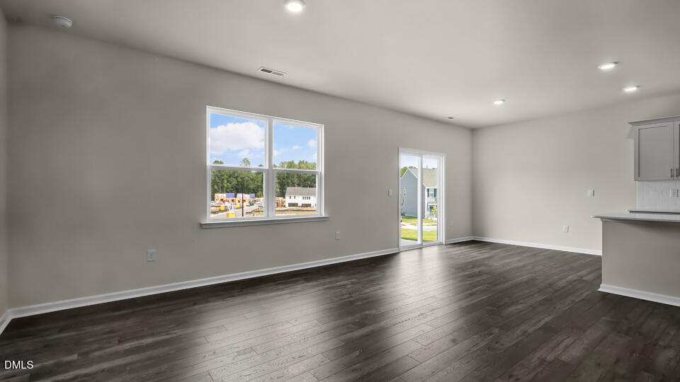 1277 Pavo Path Wendell, NC 27591 - Photo 16 of 53 an empty room with wooden floor and windows