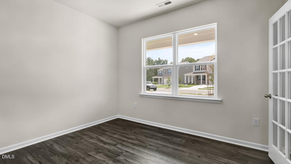 1277 Pavo Path Wendell, NC 27591 - Photo 6 of 53 a view of an empty room with wooden floor and a window