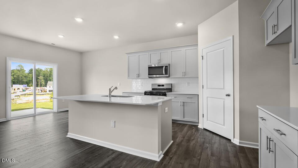 1277 Pavo Path Wendell, NC 27591 - Photo 8 of 53 a kitchen with appliances cabinets and a sink