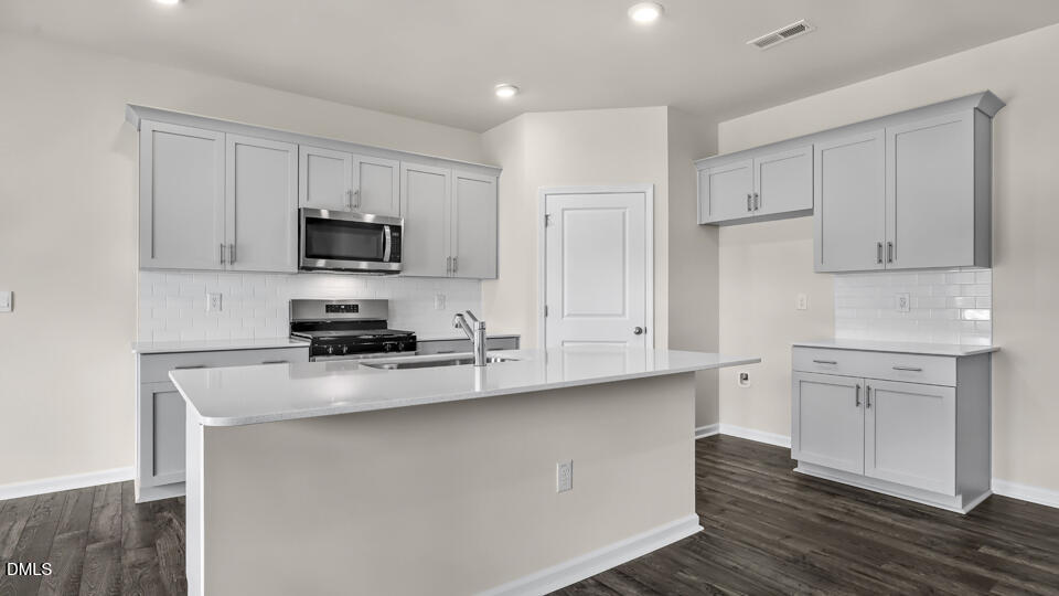 1277 Pavo Path Wendell, NC 27591 - Photo 10 of 53 a kitchen with cabinets stainless steel appliances and a counter space