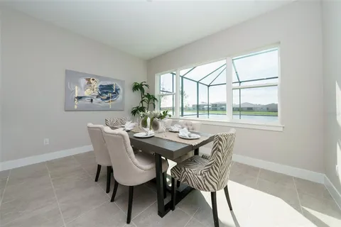 a dining room with furniture and window