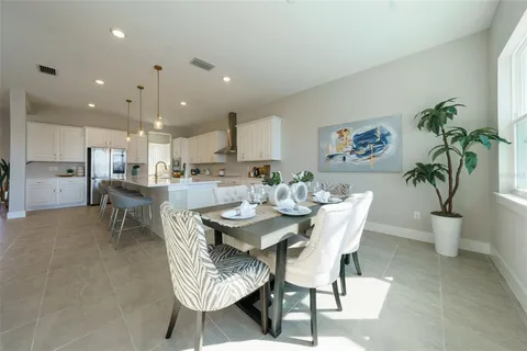 a kitchen with a table and chairs