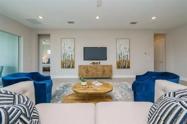 a living room with couches and a flat screen tv