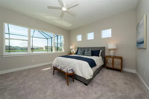 a spacious bedroom with a bed and a large window
