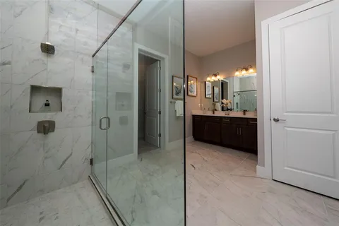 a bathroom with a double vanity sink toilet and shower