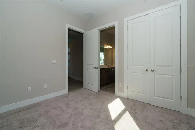an empty room with closet and a bathroom
