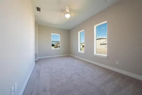 an empty room with windows and closet