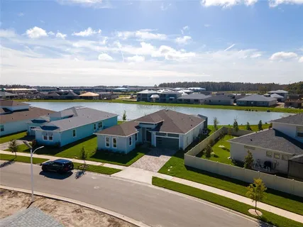 a view of a lake with couches and city view