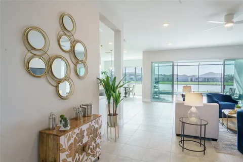 a living room with furniture and a floor to ceiling window