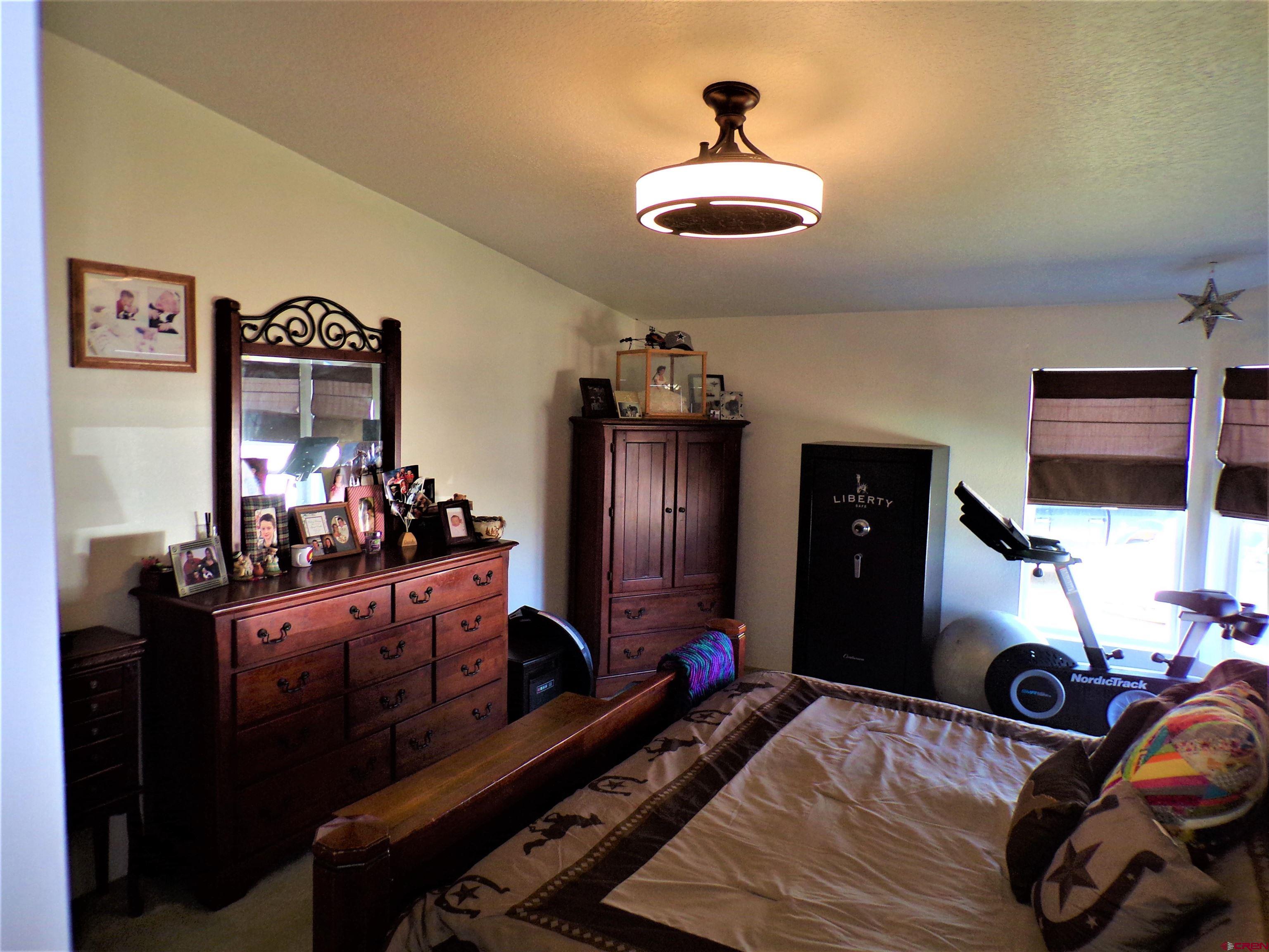 24085 Rd North Cortez, CO 81321 - Photo 11 of 34 a bed room with furniture and a ceiling fan