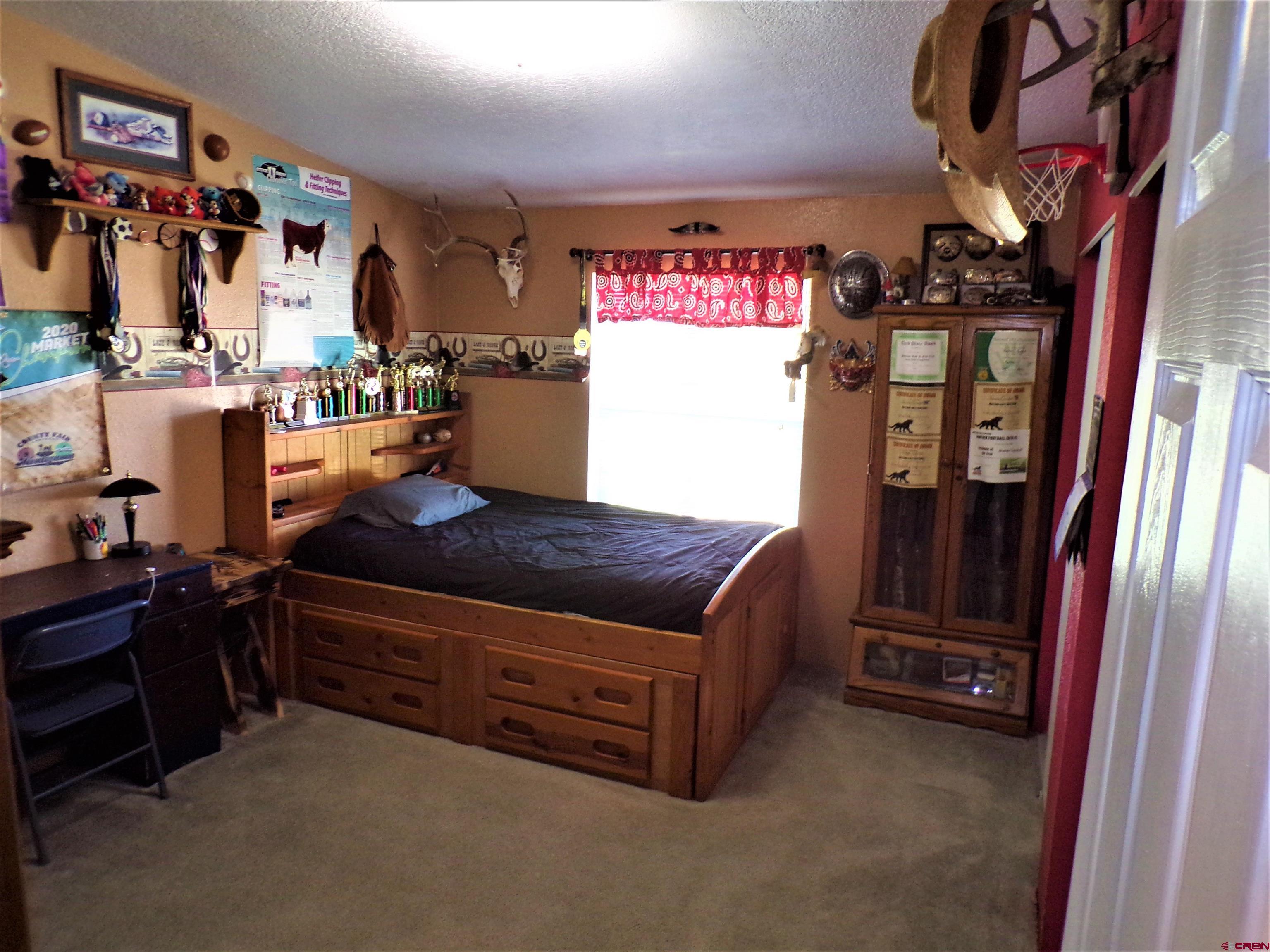 24085 Rd North Cortez, CO 81321 - Photo 14 of 34 a room with furniture and a flat screen tv
