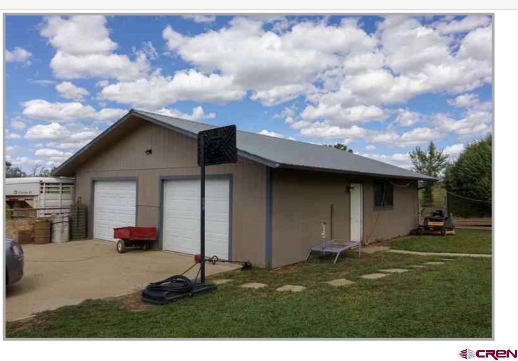 24085 Rd North Cortez, CO 81321 - Photo 21 of 34 a backyard of a house with lots of green space