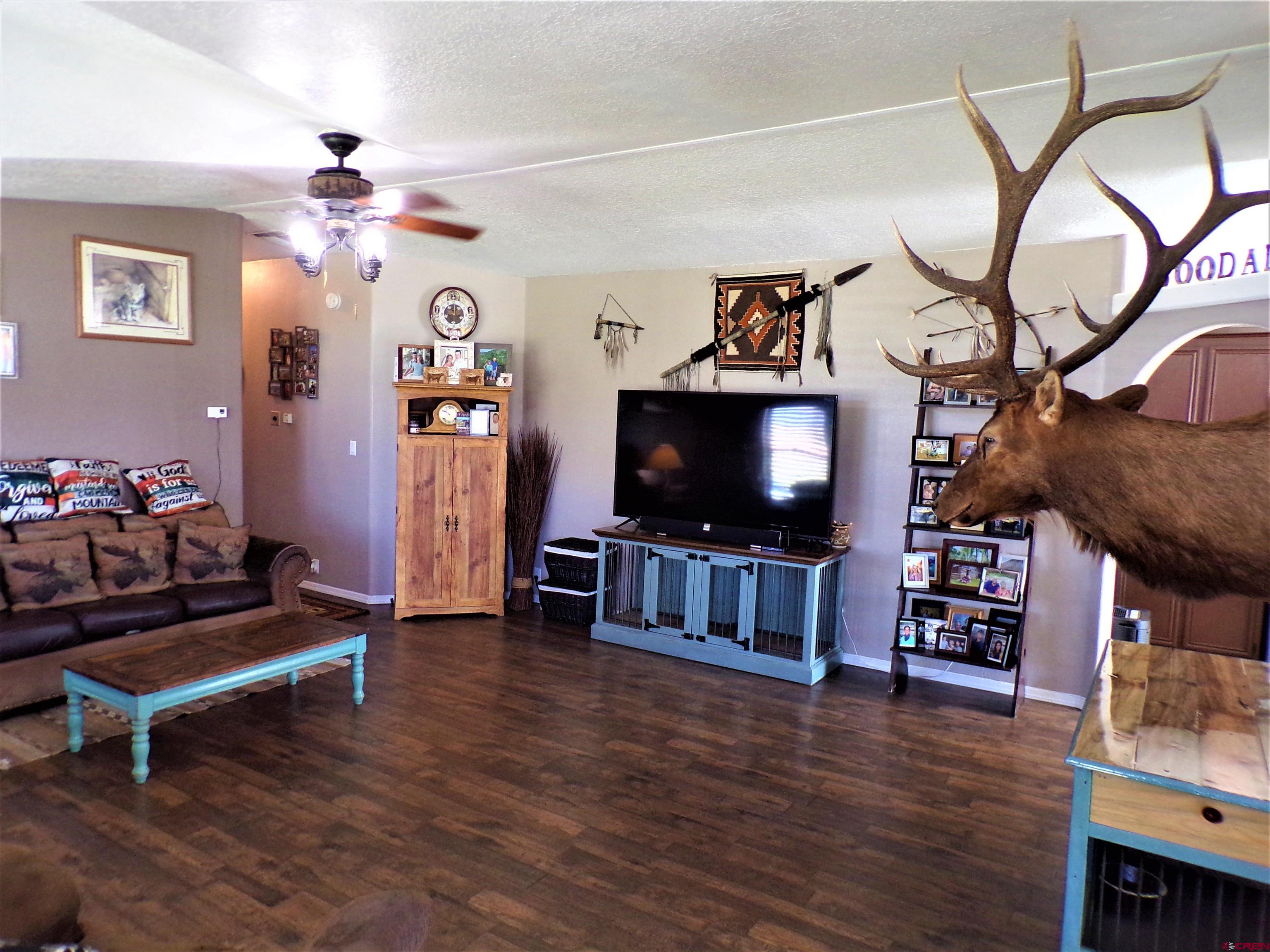 24085 Rd North Cortez, CO 81321 - Photo 4 of 34 a living room with furniture and a flat screen tv