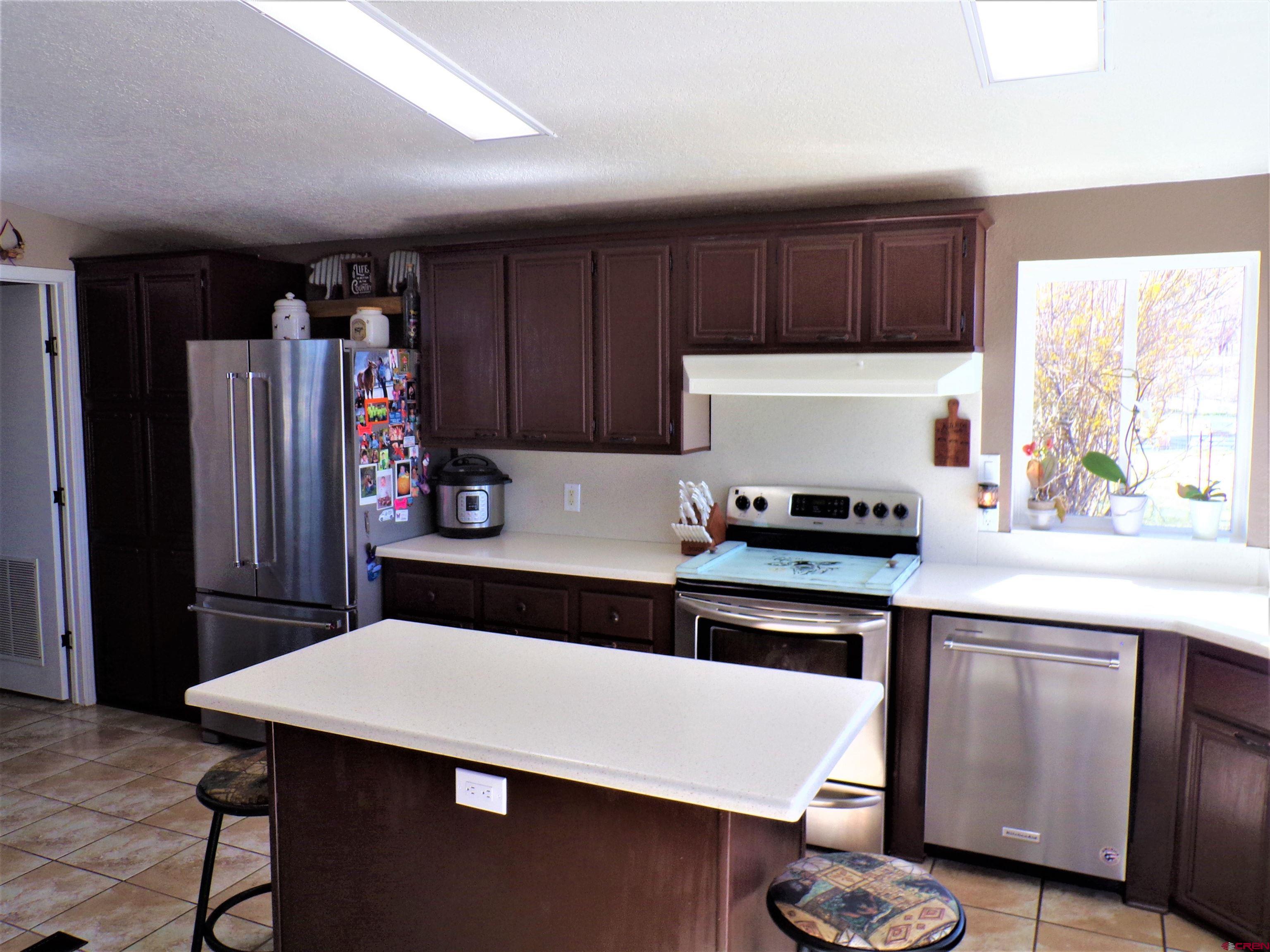 24085 Rd North Cortez, CO 81321 - Photo 7 of 34 a kitchen with stainless steel appliances a sink a refrigerator and a stove