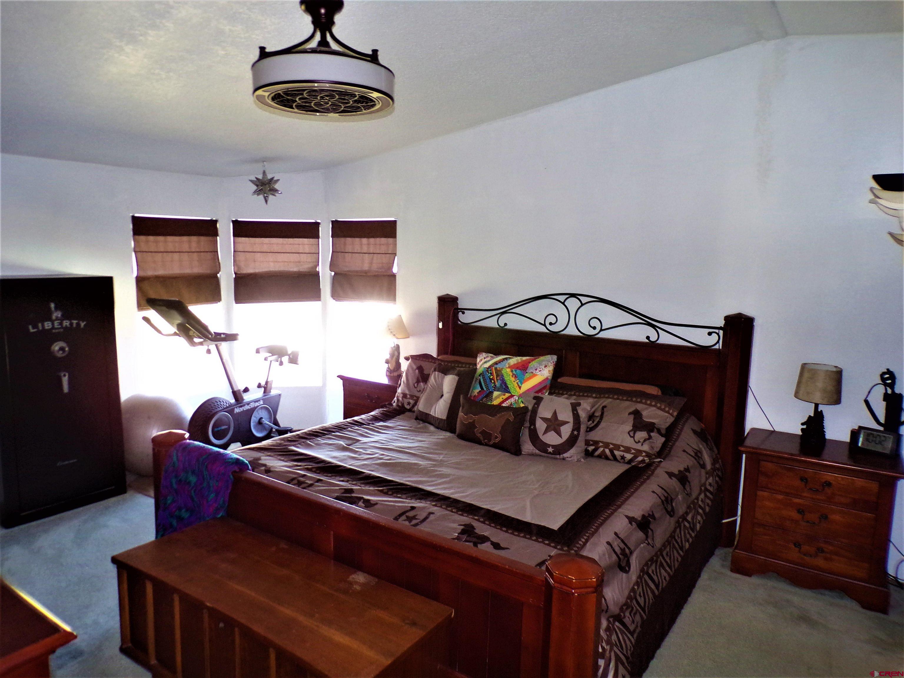 24085 Rd North Cortez, CO 81321 - Photo 10 of 34 a bedroom with a bed and wooden floor
