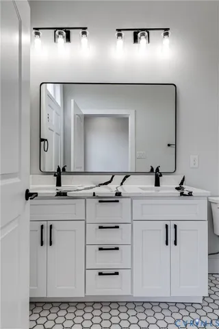 a bathroom with a double vanity sink mirror and double