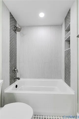 a bathroom with a toilet and a bathtub