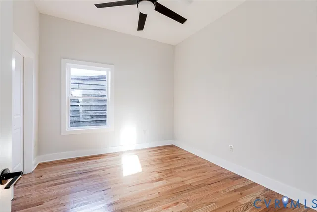 wooden floor in an empty room with a window