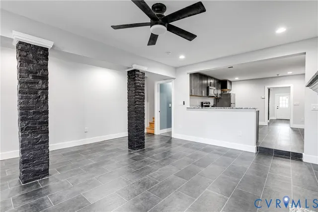a view of kitchen with furniture and a ceiling fan
