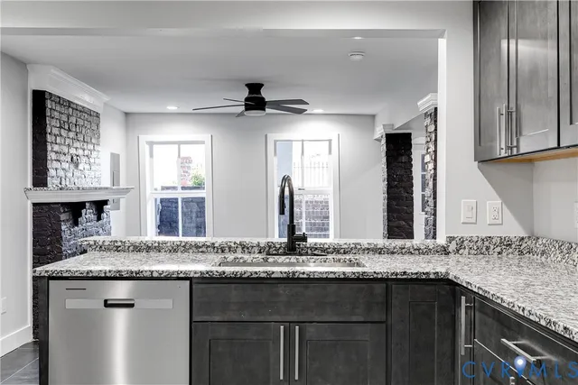 a bathroom with a granite countertop sink a mirror and window
