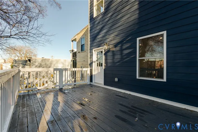 a view of balcony with wooden floor and fence