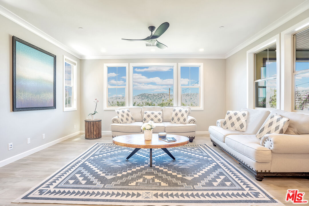 17 Lustre Street Rancho Mission Viejo, CA 92694 - Photo 12 of 63 a living room with a couch a table and a large window