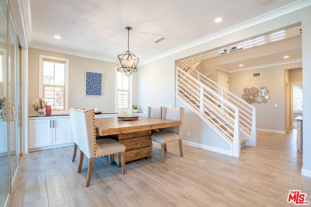 17 Lustre Street Rancho Mission Viejo, CA 92694 - Photo 18 of 63 a living room with a table chairs and a wooden floor