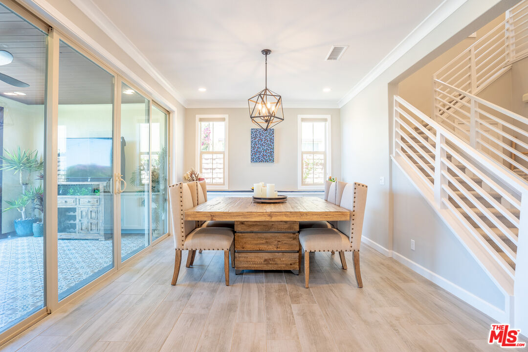 17 Lustre Street Rancho Mission Viejo, CA 92694 - Photo 19 of 63 a dining room with wooden floor a chandelier a wooden table and chairs