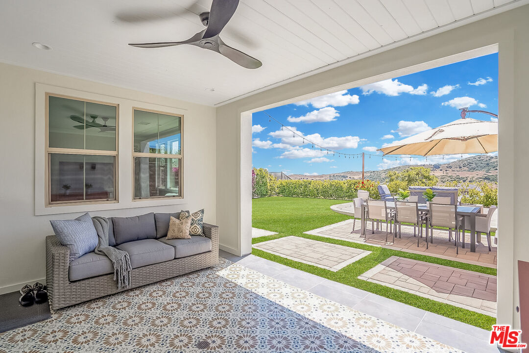 17 Lustre Street Rancho Mission Viejo, CA 92694 - Photo 22 of 63 a living room with patio furniture and a floor to ceiling window