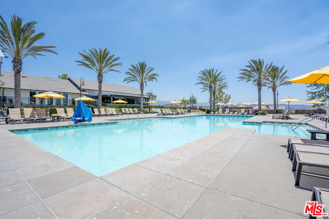 17 Lustre Street Rancho Mission Viejo, CA 92694 - Photo 51 of 63 a view of swimming pool with outdoor seating and house in the background
