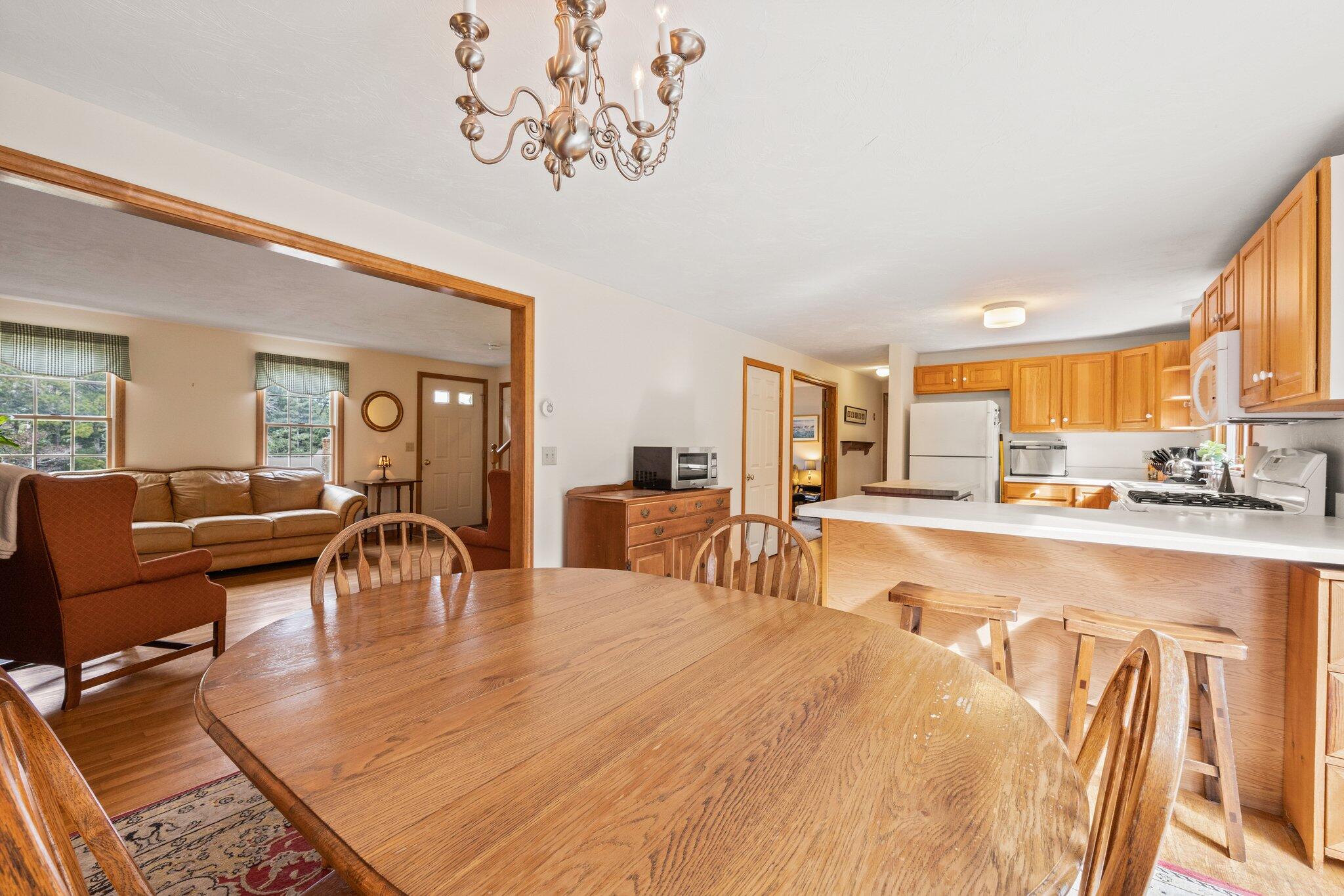 31 Hillside Road Harwich, MA 02645 - Photo 11 of 35 a view of a dining room with furniture a chandelier and wooden floor