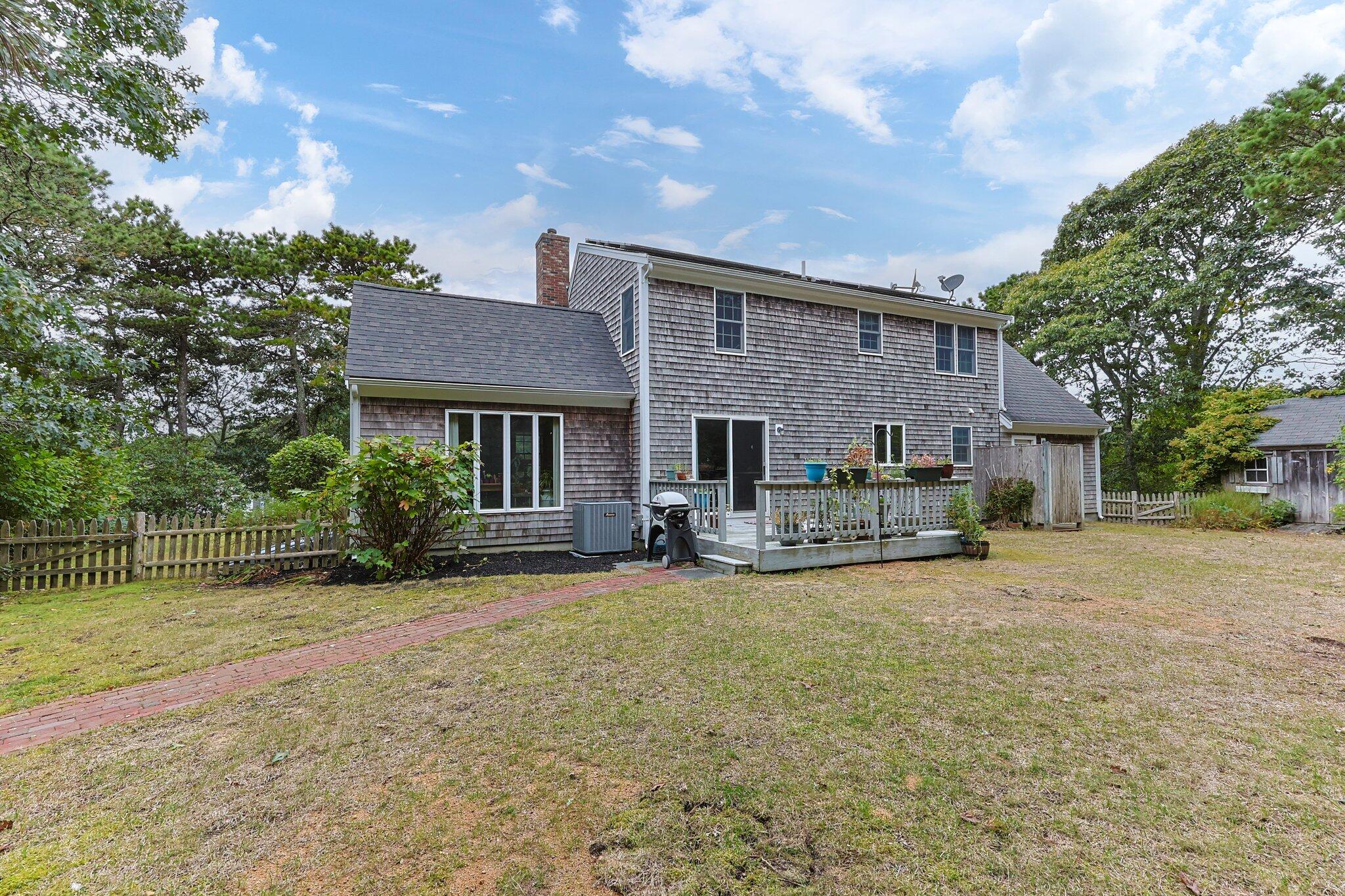 31 Hillside Road Harwich, MA 02645 - Photo 28 of 35 a view of a house with a yard and sitting area