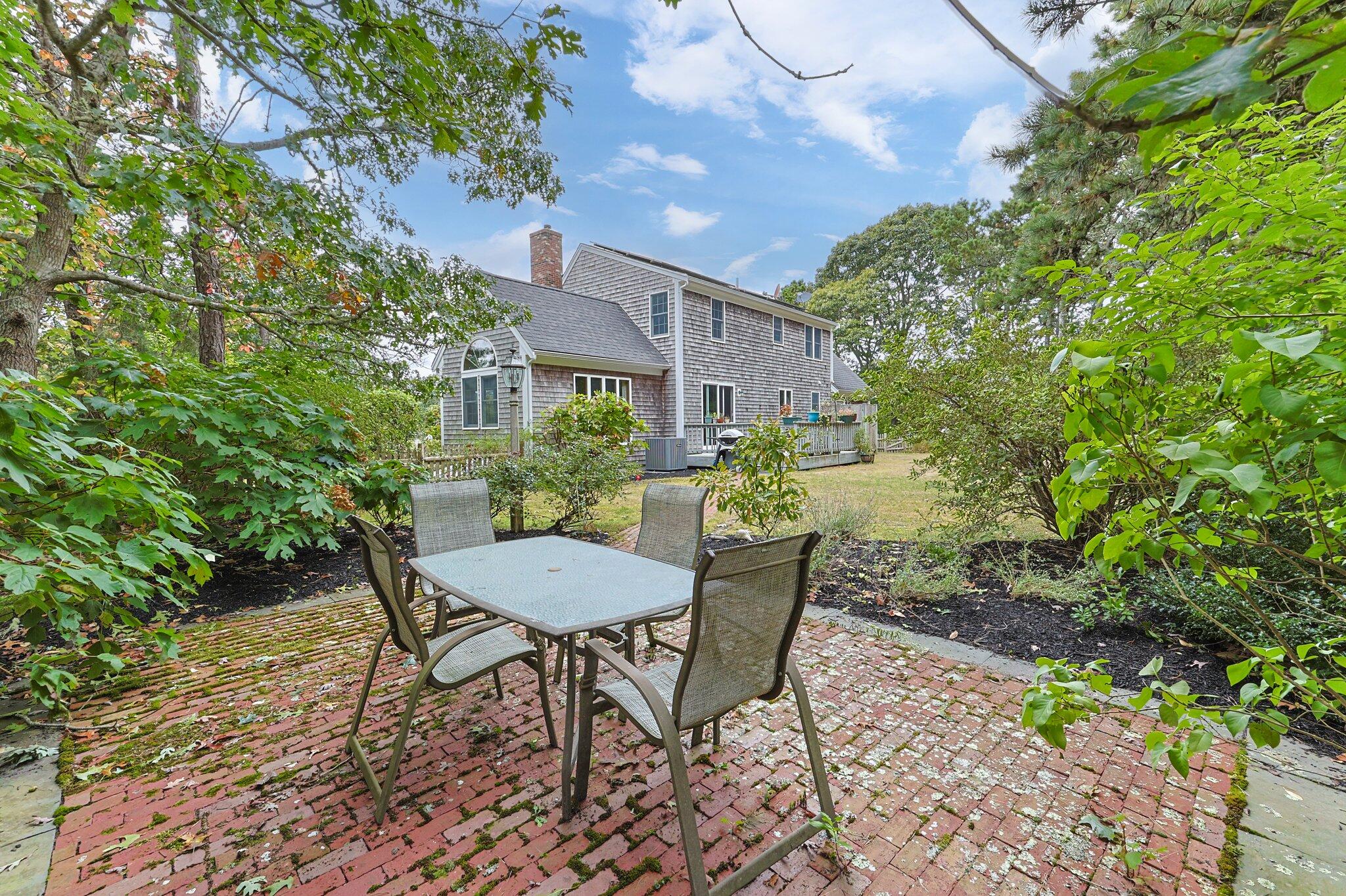 31 Hillside Road Harwich, MA 02645 - Photo 30 of 35 a view of a table and chairs in the backyard