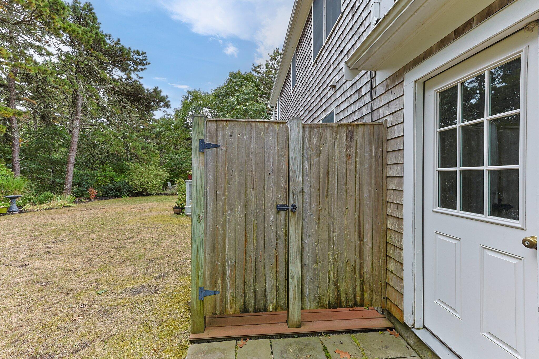 31 Hillside Road Harwich, MA 02645 - Photo 33 of 35 a view of a backyard with a door and wooden fence