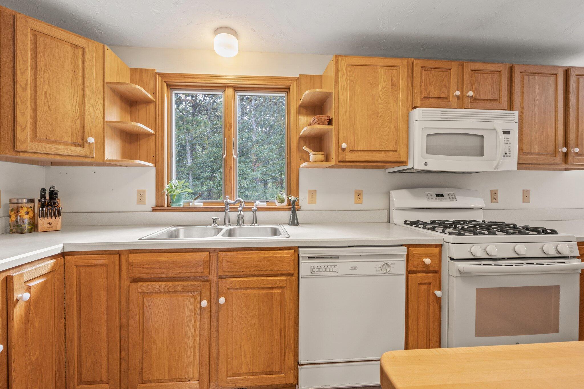 31 Hillside Road Harwich, MA 02645 - Photo 7 of 35 a kitchen with a sink stove and cabinets
