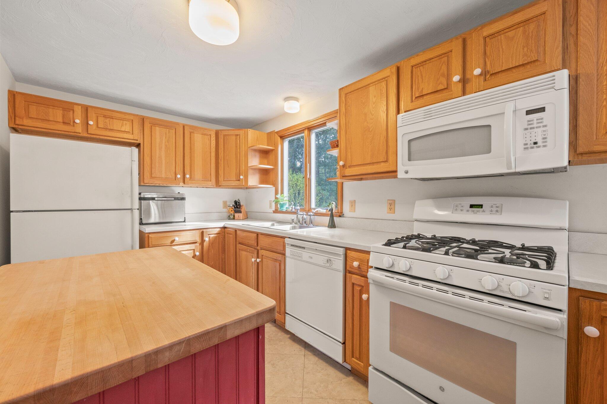 31 Hillside Road Harwich, MA 02645 - Photo 8 of 35 a kitchen with a stove a sink dishwasher and a refrigerator
