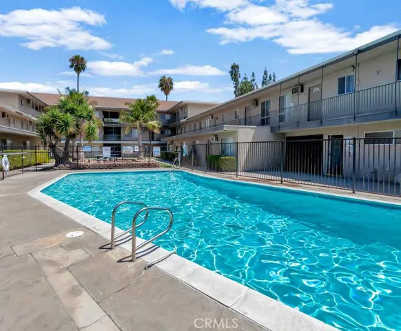 a swimming pool with outdoor seating and yard