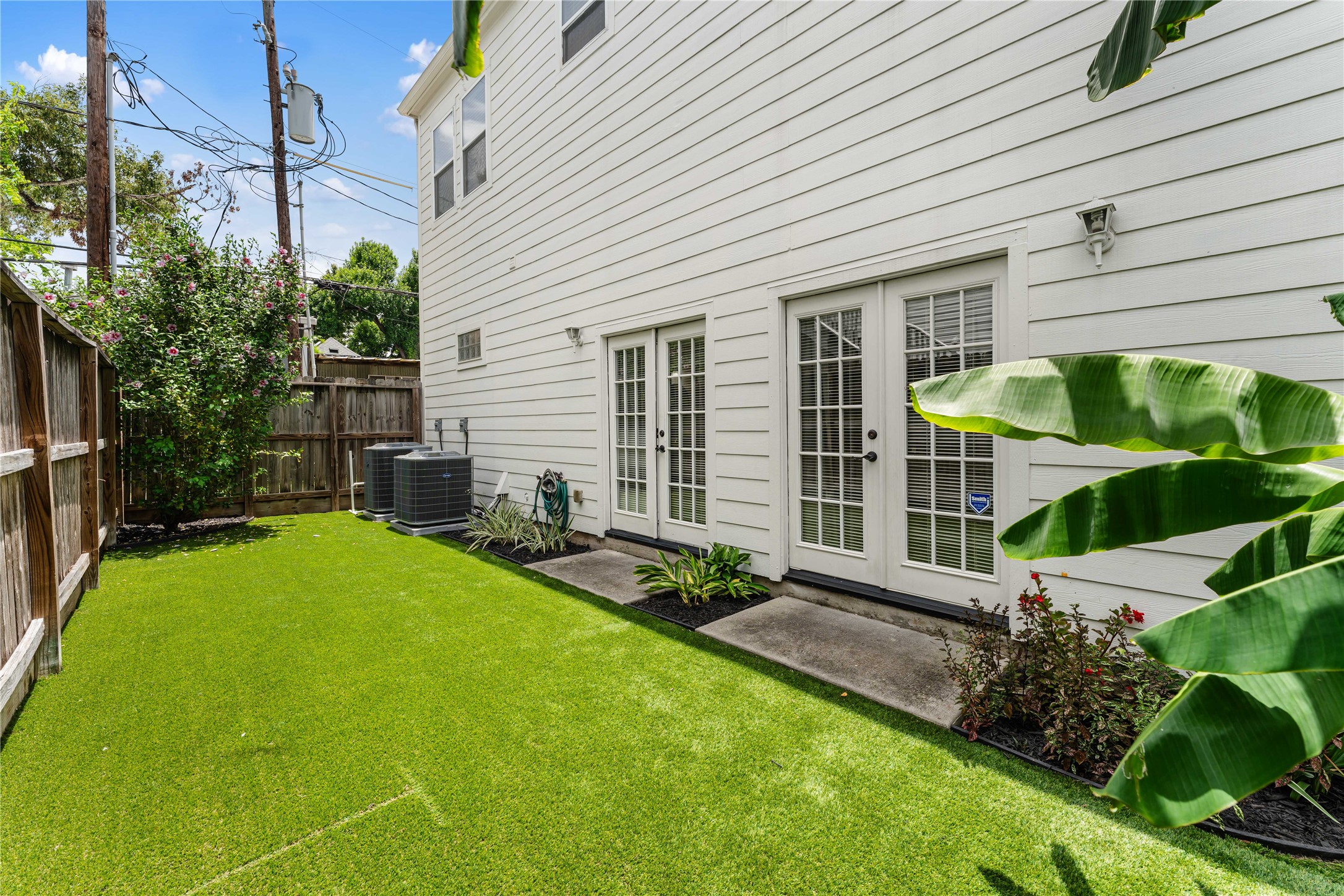 415 West 8th Street Houston, TX 77007 - Photo 17 of 39 French doors provide seamless access from the home to this private backyard oasis. Artificial turf keeps maintenance to a minimum while offering year-round greenery and a perfect space to relax, entertain, or let pets roam.
