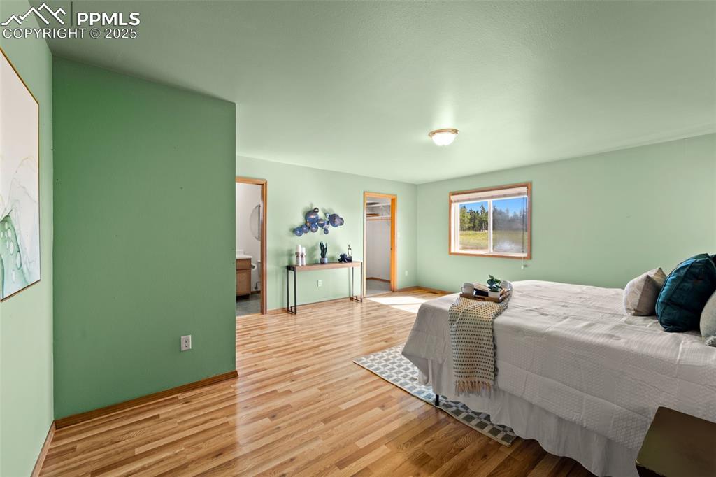 428 Ridge Drive Divide, CO 80814 - Photo 23 of 49 a bedroom with a bed and wooden floor