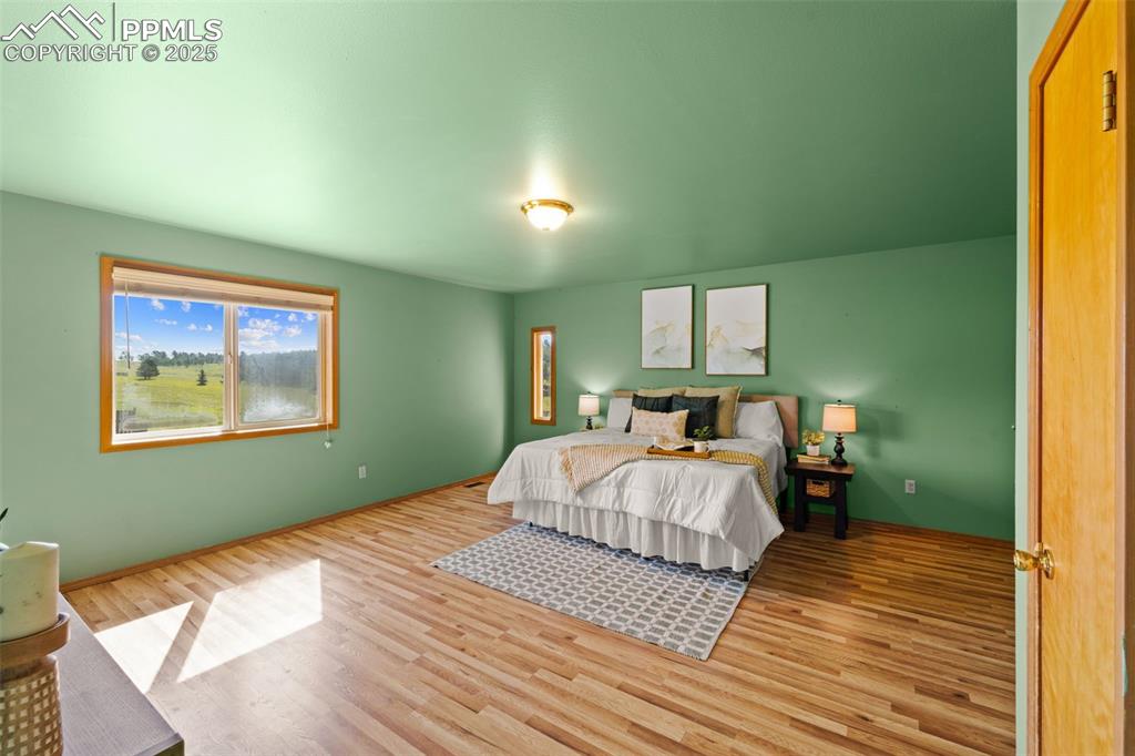 428 Ridge Drive Divide, CO 80814 - Photo 24 of 49 a bedroom with a bed and a painting on the wall