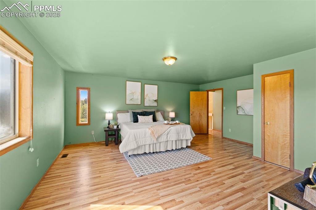 428 Ridge Drive Divide, CO 80814 - Photo 25 of 49 a spacious bedroom with a bed and wooden floor