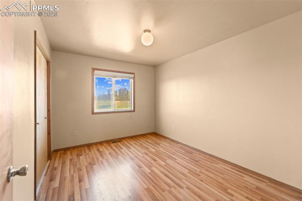 428 Ridge Drive Divide, CO 80814 - Photo 27 of 49 a view of an empty room with wooden floor and a window