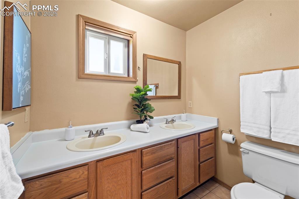 428 Ridge Drive Divide, CO 80814 - Photo 29 of 49 a bathroom with a granite countertop sink toilet and a mirror
