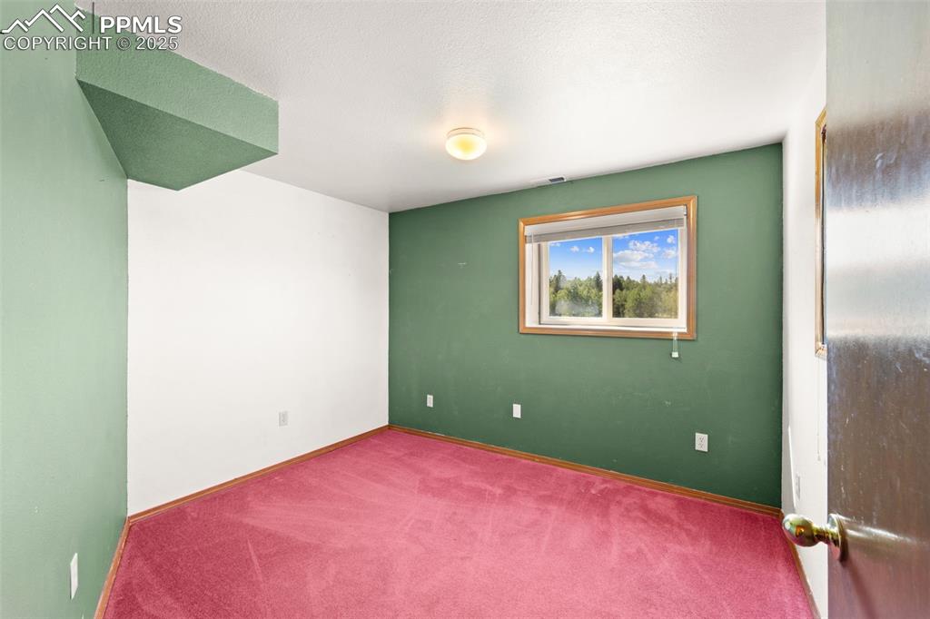 428 Ridge Drive Divide, CO 80814 - Photo 31 of 49 a bedroom with a bed and a window