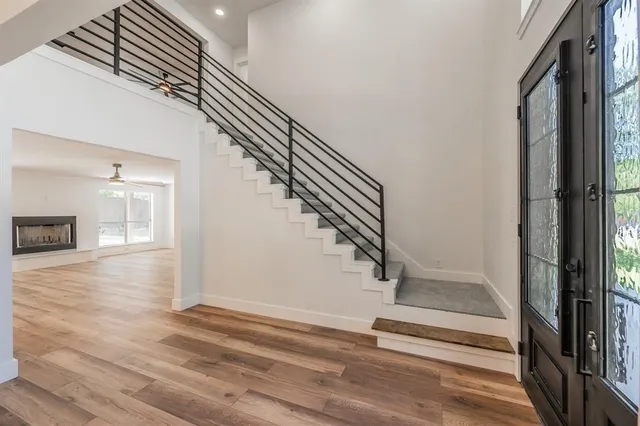 a view of entryway and hall with wooden floor