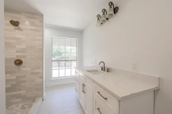 a bathroom with a sink a vanity and a mirror