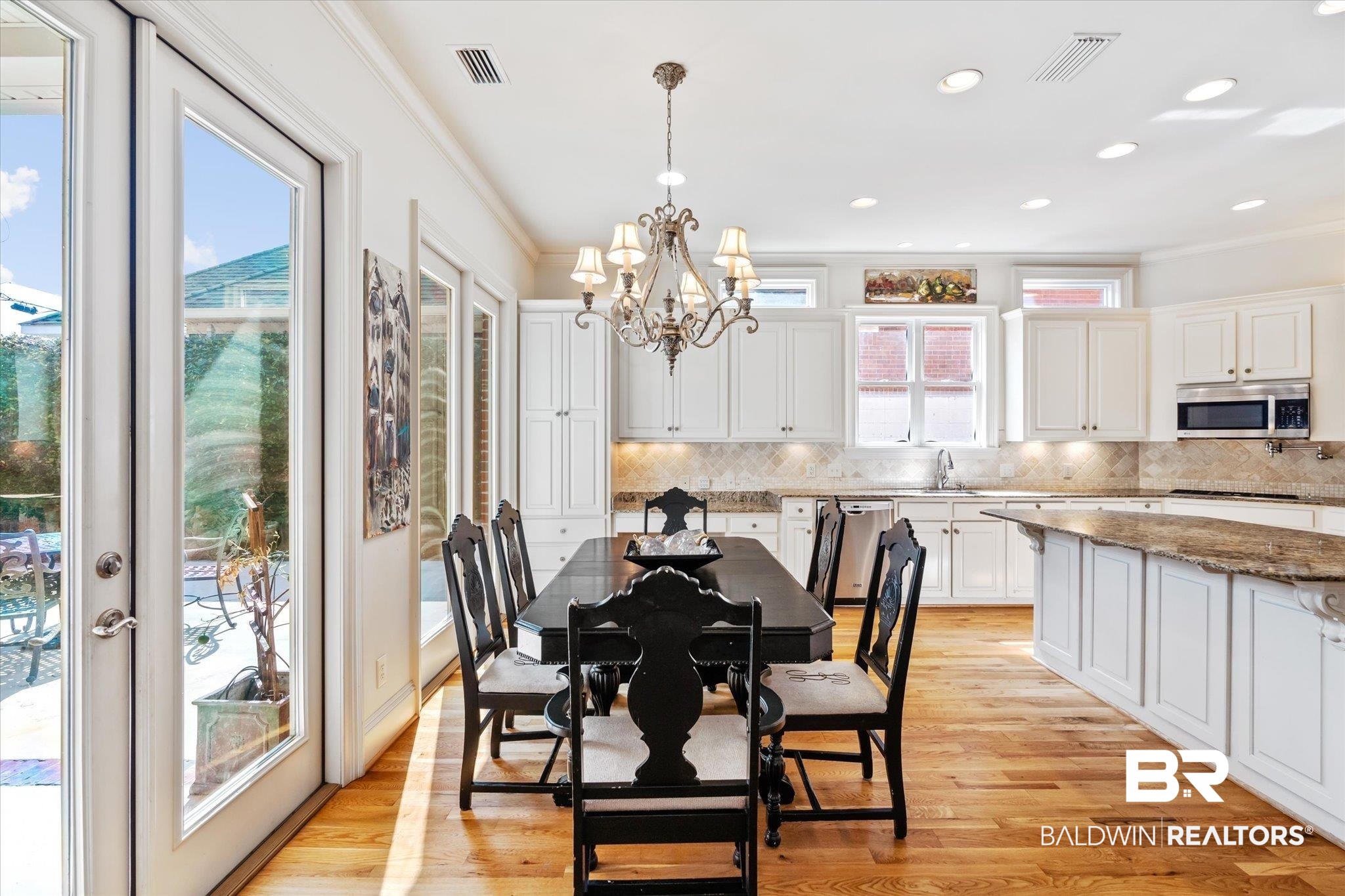 3963 Wimbledon Park Mobile, AL 36608 - Photo 14 of 51 Dining space featuring crown molding, light hardwood / wood-style floors, and a chandelier