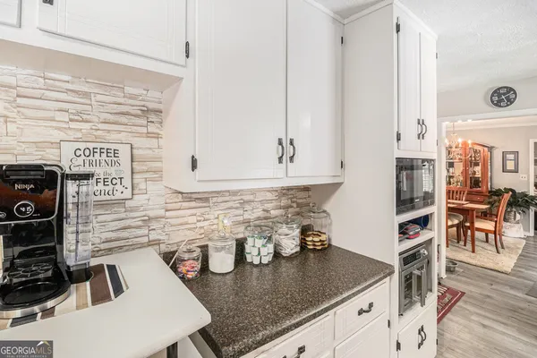 a kitchen with sink stove and cabinets